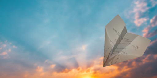 Paper Plane in cloudy Sky